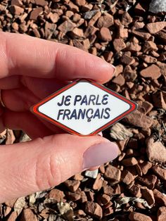 a person is holding up a sticker that says je parle franois