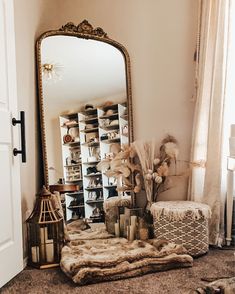 a mirror sitting on top of a floor next to a shelf filled with boxes and baskets