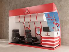 an exhibition stand with chairs and a sign on it that says emirates's first class