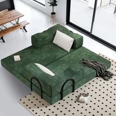 a green couch sitting on top of a white floor