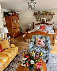 a living room filled with lots of furniture and flowers on top of a coffee table