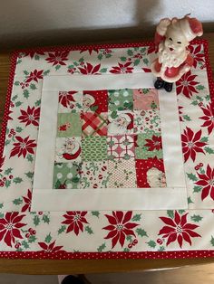 This festive Retro Santa table topper is 16" square. This is Swell Christmas fabric collection, by Moda.  This fabric is no longer available .It would make a nice gift for a teacher, family member, friend or a gift to yourself.    I cut and pieced together this table topper in my smoke free home.  The table topper is machine quilted.   The batting or middle is Warm and White cotton batting. The backing is a 100% Cotton. This fabric has Not been pre washed. Washing instructions:  Wash in cold/warm water and tumble dry on med. heat.  Fabrics are 100% cotton. Christmas Table Toppers Free Pattern, Swell Christmas, Santa Table, Xmas Table Runners, Quilted Table Runners Christmas, Christmas Table Toppers, Christmas Blocks, Christmas Sewing Projects, Christmas Craft Fair