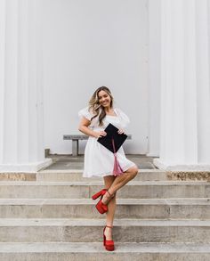 a woman is posing on some steps