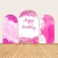 a happy birthday card with pink and gold paint splattered on the back wall