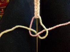 a close up view of someone's pants with some yarn on the end of them