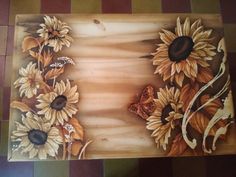 a painting of sunflowers and butterflies on a wood paneled floor with tile