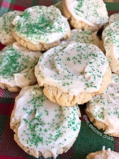 green sprinkles on top of white frosted cookies