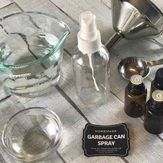 the ingredients for homemade garbage can spray are displayed on a wooden table top