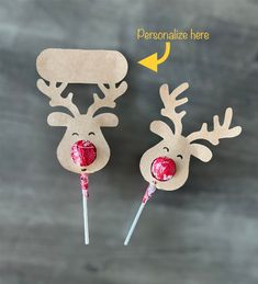 two reindeer lollipops with candy on them