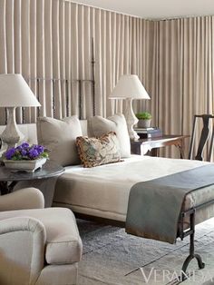 a large bed sitting next to a window in a bedroom