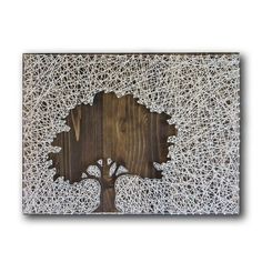 a wooden wall hanging with a tree cut out of it's bark and branches