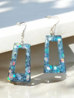 Blue resin earrings with alcohol ink and glitter. Super shiny and pretty when the light hits. Resin Glitter Earrings, Blue Resin Earrings For Beach, Elegant Blue Resin Earrings, Blue Resin Teardrop Earrings, Artsy Blue Resin Earrings, Blue Glitter, Alcohol Ink, Craft Fairs, Jewelry Earrings Dangle