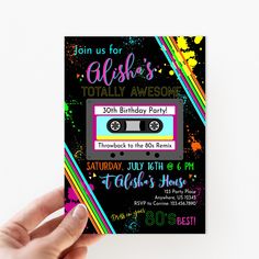 a hand holding up a birthday party card with an old school cassette tape on it