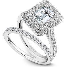 a diamond engagement ring set with an emerald center surrounded by diamonds