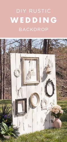 an outdoor wedding backdrop with flowers and pictures on it, in the grass next to some potted plants