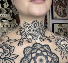 a woman with tattoos on her neck and chest