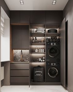 a washer and dryer in a small room with dark colored cabinets on the wall