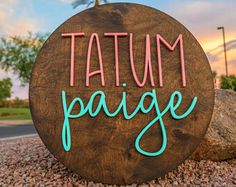 a sign that says,'tatum paage'in front of some rocks