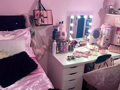 a bedroom with a vanity, mirror and lights on it's sides is pictured in this image