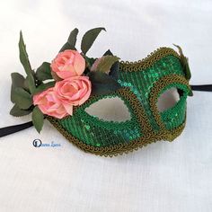 Green sequin masquerade mask decorated with kelly-green and olive-green trims, rose leaves and 3 small pink fabric roses. Plastic base covered in sequined fabric on the outside and black felt on the inside for comfort. Ribbon ties. Designer mask hand made in Australia. Laura Lucci's Collection. NOTE: Dispatch is from Melbourne, Australia. Shipping by Australia Post. Green Masquerade Mask, Mask Venetian, Designer Mask, Sequined Fabric, Rose Leaves, Australia Post, Fabric Roses, Masquerade Mask, Green Sequins