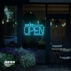 a neon sign that reads, we're open