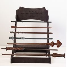 an old wooden display with several different types of swords on it's sides and the words, the way chess is the wizard