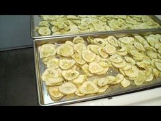 two trays filled with bananas sitting on top of a counter