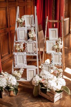 an arrangement of frames and flowers on display