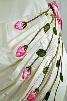 a white dress with pink flowers on it