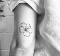 a black and white photo of a flower on the arm