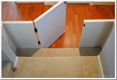 an open door on the side of a wooden floor next to a carpeted stair case