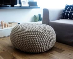 a living room with a couch, chair and ottoman