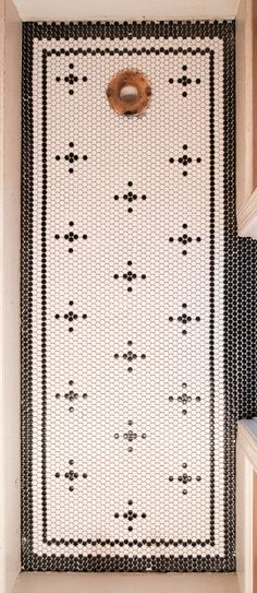 a black and white rug hanging on the side of a wall