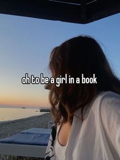 a woman standing on top of a beach next to the ocean with text that reads, oh to be a girl in a book