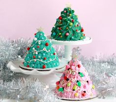 three decorated christmas trees sitting on top of plates