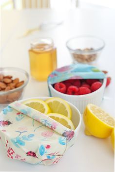 the table is full of fruits, nuts, and other food items to be eaten