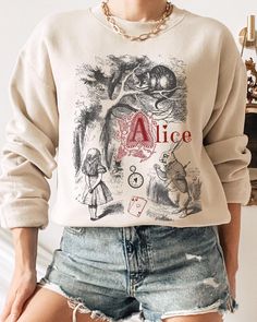 THE VINTAGE ALICE SWEATSHIRT We are super excited for you to get your hands on this new design Gildan sweatshirt. This product is very on trend and we hope you love it! 💜 If you would like to discuss any alternative size, color or product options, please do not hesitate to contact us directly. 💌 THIS DESIGN IS ALSO AVAILABLE AS A T-SHIRT: ➡️ ➡️ ➡️ https://www.etsy.com/uk/listing/1779881425/vintage-alice-alice-in-wonderland-shirt ✨ ABOUT OUR CREWNECK SWEATERS ✨ Our crewneck sweaters are pure co Vintage Sweatshirt With Cartoon Print, Themed Long Sleeve Tops With Graphic Print, Themed Long Sleeve Tops With Letter Print, Themed Long Sleeve Letter Print T-shirt, Themed Long Sleeve T-shirt With Letter Print, Alice Alice In Wonderland, Flat Lay Photos, Crewneck Sweaters, Gildan Sweatshirt