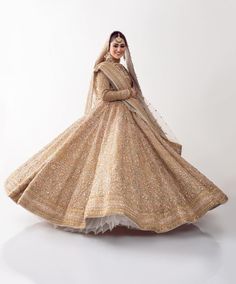 The embellished Golden Lehenga Choli with Dupatta Dress is a traditional masterpiece adorned with hand-crafted details of embroidery and ornaments. The huge flare of the Bridal Lehenga and lavish zardosi make this Bridal Wedding Dress an epitome of beauty. Bridal Choli: The choli has an alluring dull-gold shade. Graceful embroidery and intricate designs make this beautiful golden choli a perfect choice to pair with the Lehenga. Zardosi and shimmering sequins give a glamorous touch to the perfect Bridal Choli, Double Dupatta, Sitara Work, Golden Lehenga, Pakistani Bridal Lehenga, Dupatta Dress, Wedding Dresses Pakistani, Golden Gown, Bridal Mehndi Dresses