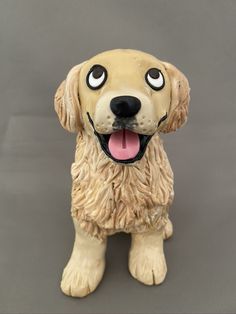 a dog figurine has its tongue out and it's eyes wide open