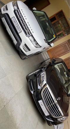 two cars parked next to each other in front of a building