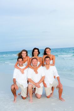 a family poses for a photo on the beach