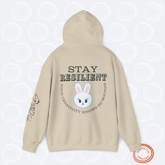 Leebit Lee Know "STAY Resilient" SKZoo Hoodie with Inspirational Quote | Stray Kids Unisex Hooded Sweatshirt for STAYs STAY inspired and cozy with this set of SKZoo hoodies, featuring your favorite Stray Kids characters alongside uplifting quotes featuring a reference to the best fans in the world. This collection of Rhyming Orange-designed hoodies are designed to empower every STAY and celebrate the incredible qualities of the group members. Made from a soft 50% cotton, 50% polyester blend, these Gildan unisex heavy blend hoodies provide comfort and style with a classic fit, double-lined hood, and kangaroo pocket. Perfect for expressing your love for SKZ while spreading positivity! Features: - Material: 50% cotton, 50% polyester - Fit: Unisex, classic fit with a double-lined hood - Ribbed Designed Hoodies, Kids Characters, Spreading Positivity, Orange Design, Best Fan, Kpop Merch, Kid Character, Stay Inspired, Uplifting Quotes