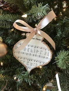 a christmas ornament hanging from the top of a tree with music notes on it