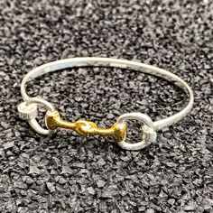 "Gold Vermeil Trimmed Double Snaffle Bit Gold Vermeil Bangle (Horsebit bangle) For horse lovers everywhere, voila... our fabulous gold vermeil and silver snaffle bit bracelet. This gold and silver snaffle bit bangle bracelet is handcrafted using the finest 925 sterling silver and will look amazing with every look and outfit.  As we have it available in both petite and standard sizes, almost everybody will find the right size for them.  As an idea for bracelets for women who love our equine friends, this is the perfect gift.  Horse themed jewelry at it's absolute finest! \"No hour of life is wasted that is spent in the saddle.\" - Winston Churchill The video shows the bangle in plain silver which can be purchased from this link: https://www.etsy.com/uk/listing/598125266/ Specification: Styl Snaffle Bit, Gold Horse, Gold And Silver Bracelets, Equestrian Gifts, Horse Jewelry, Bangles Making, Horse Bits, Eco Friendly Jewelry, Horse Lovers