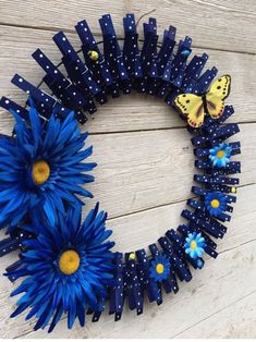 a blue wreath with daisies and butterflies on it