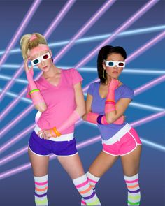 two women in pink and purple are posing