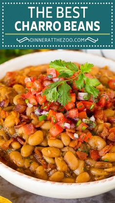 a white bowl filled with beans and garnished with cilantro on top