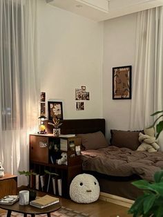 a living room with a couch, coffee table and bookshelf in the corner