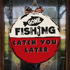 a sign that says gone fishing catch you later in front of a window with an american flag on it