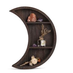 the moon shelf is made out of wood and has three shelves on each side that hold rocks, crystals, and other items